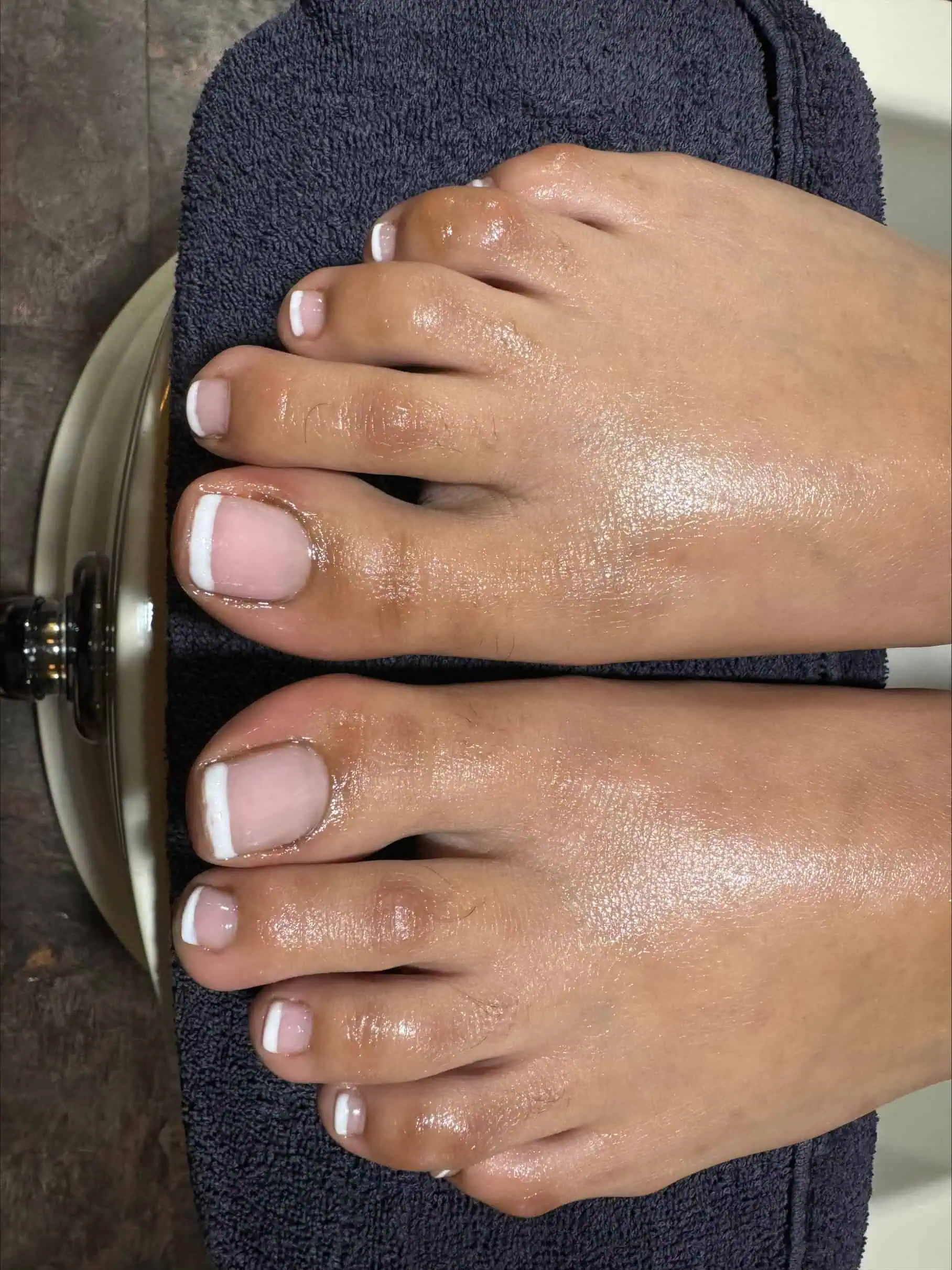 a person's feet with white toenails