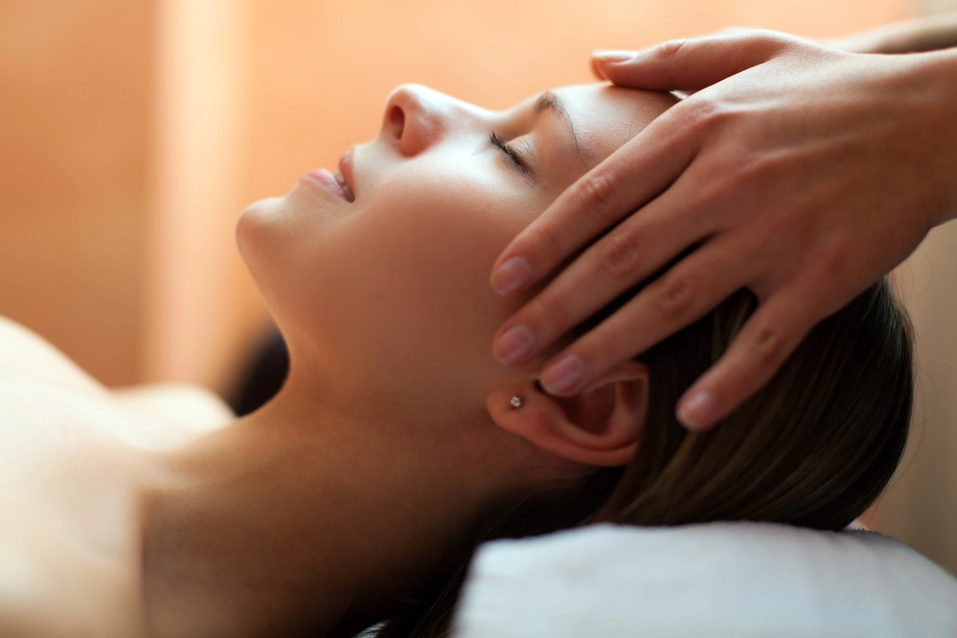 a woman receiving a head massage