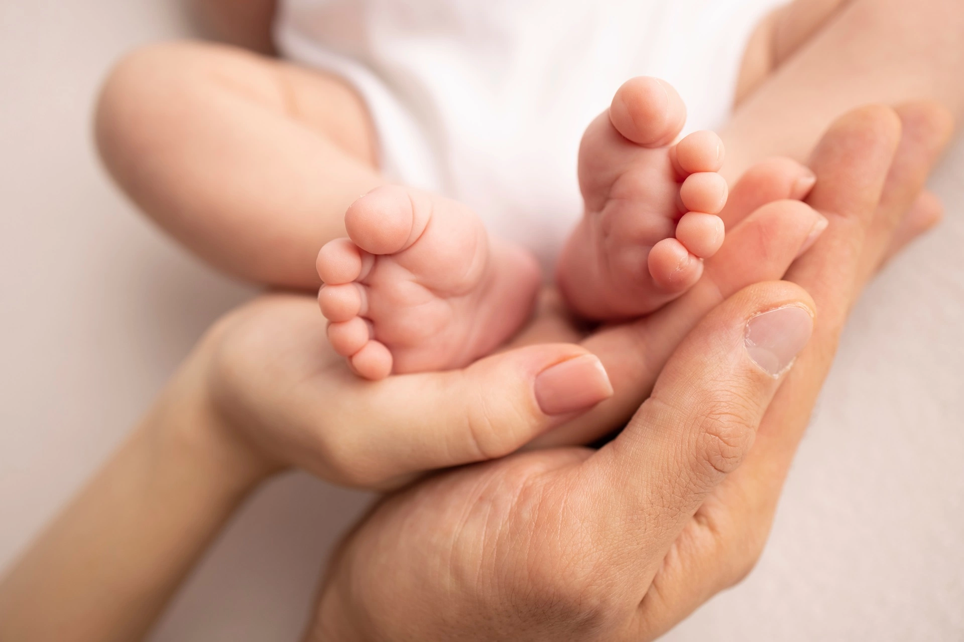 a baby's feet in a person's hands