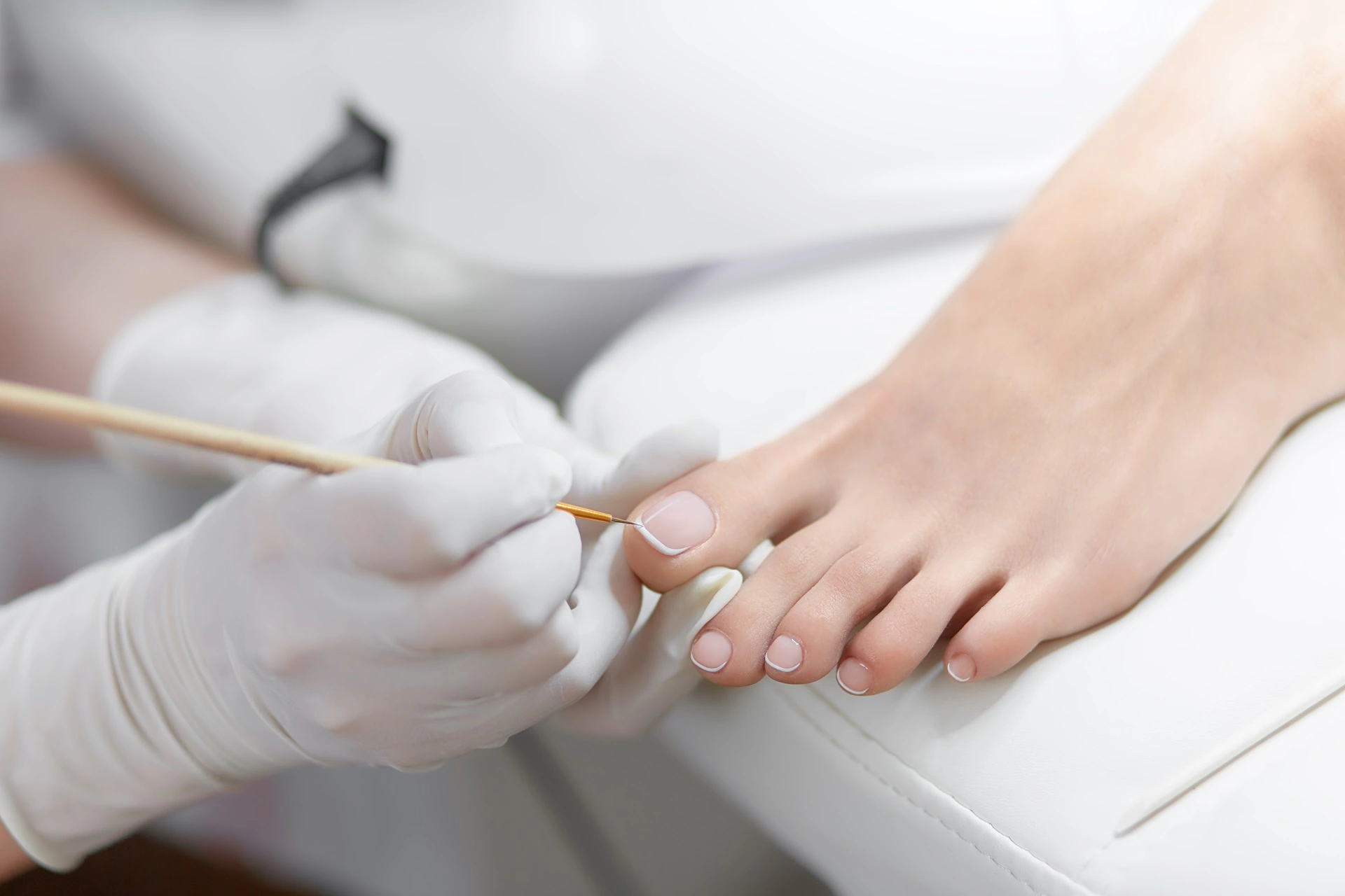 a person getting a toenail treatment