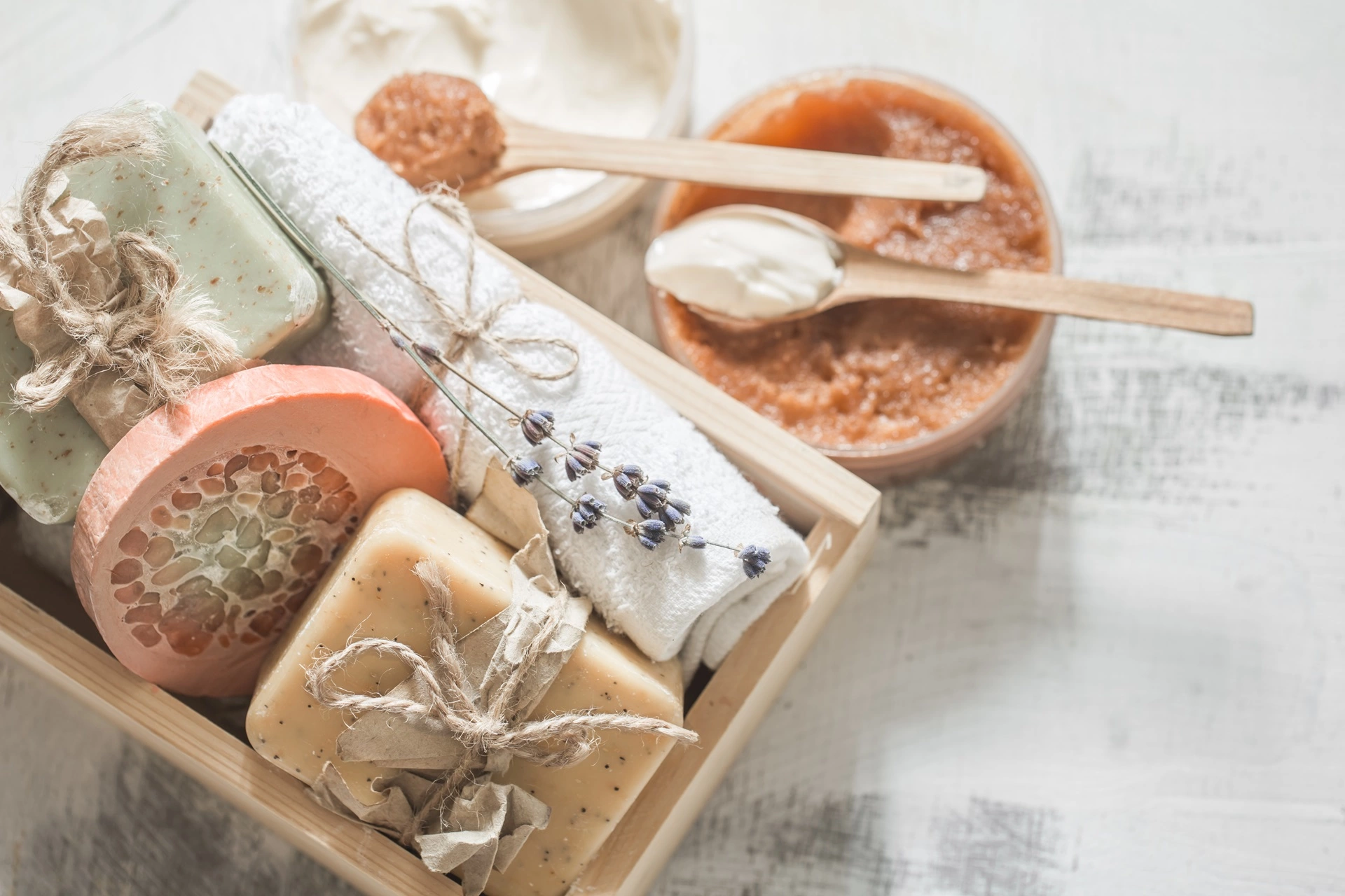 a wooden box with different types of soaps and towels