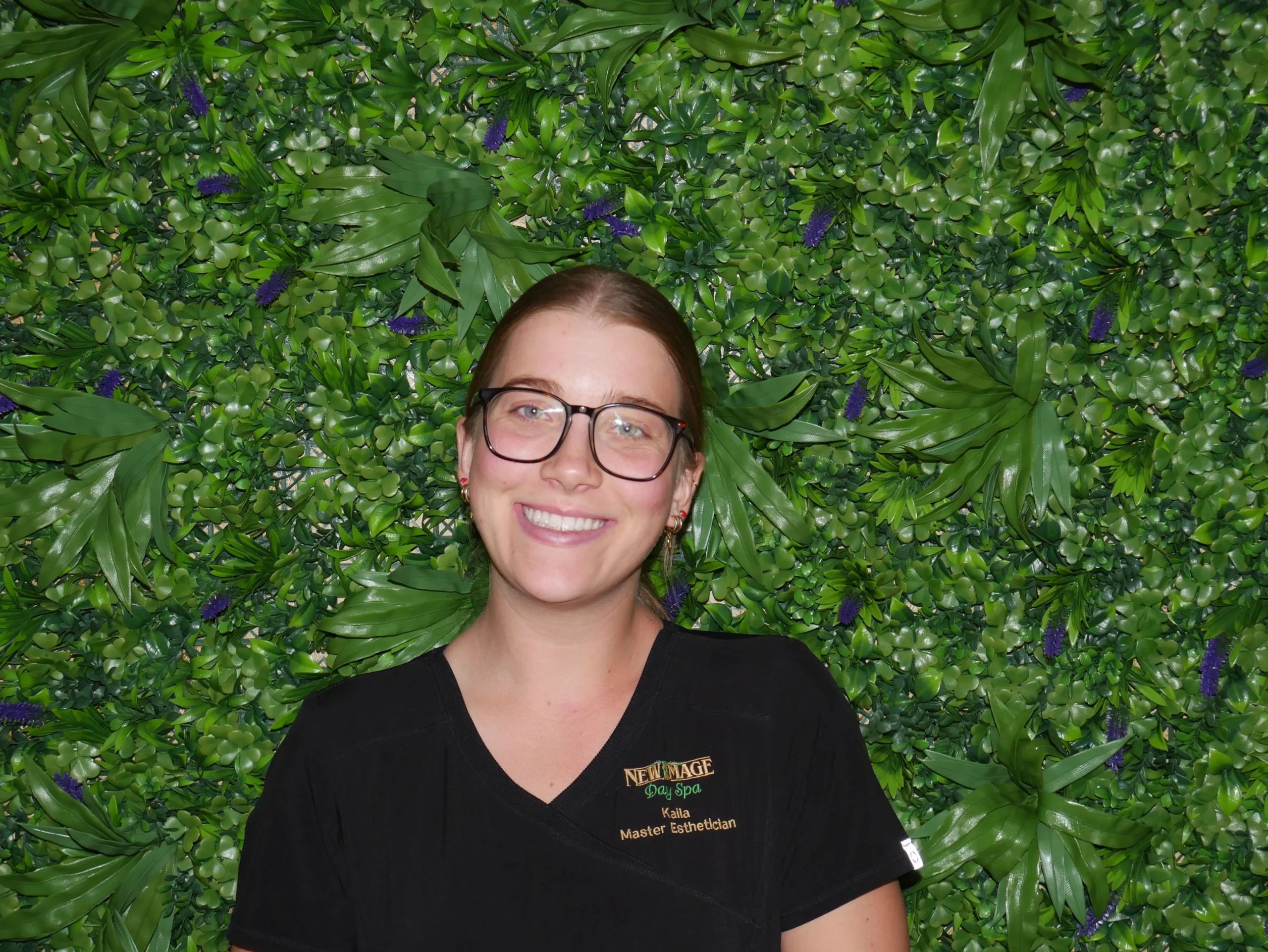 a woman wearing glasses and smiling