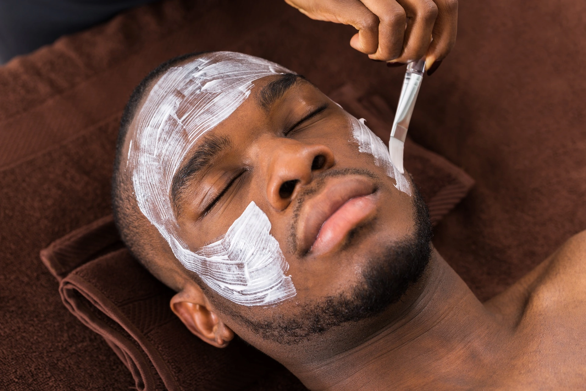 a man with white cream on his face