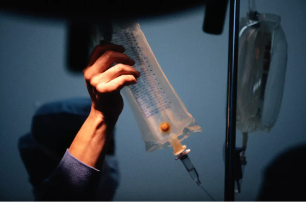 a person holding a bag of liquid