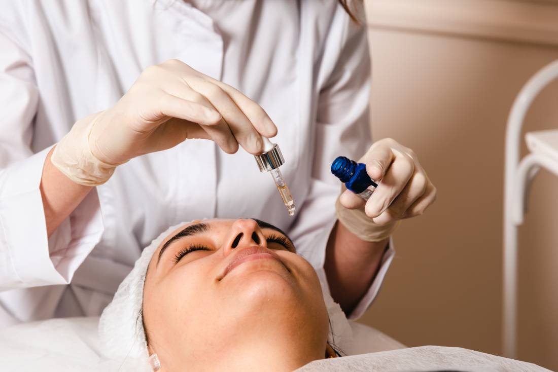 a woman receiving a facial treatment