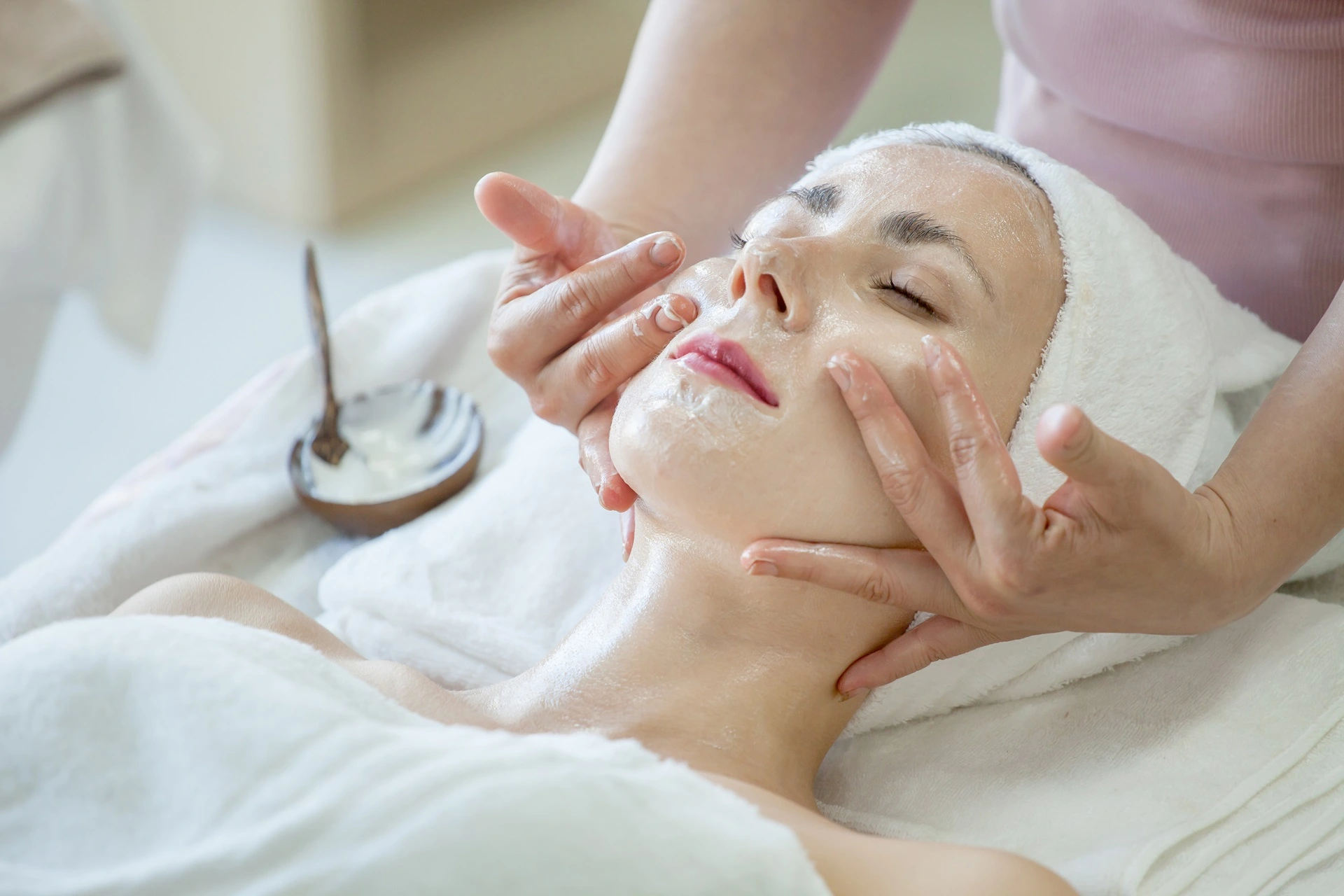 a woman receiving a face massage