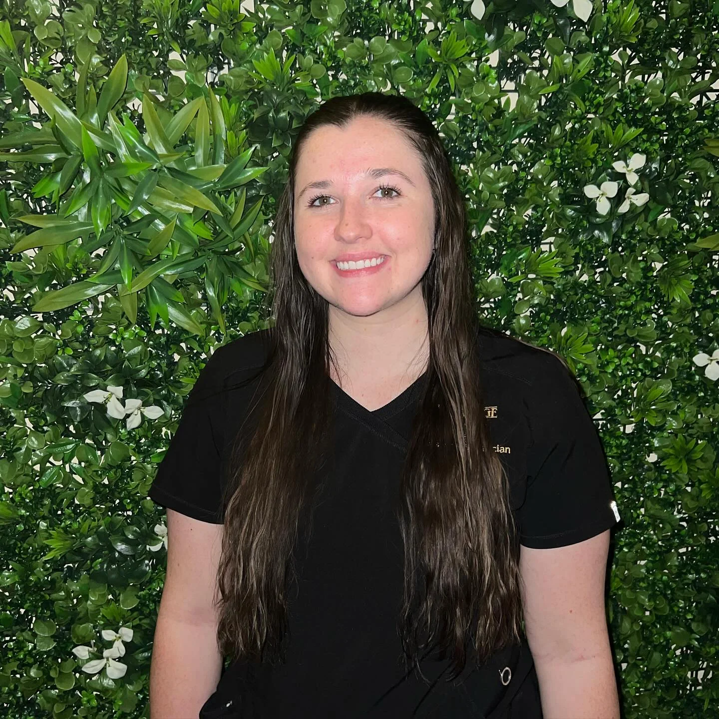 a woman standing in front of a green wall