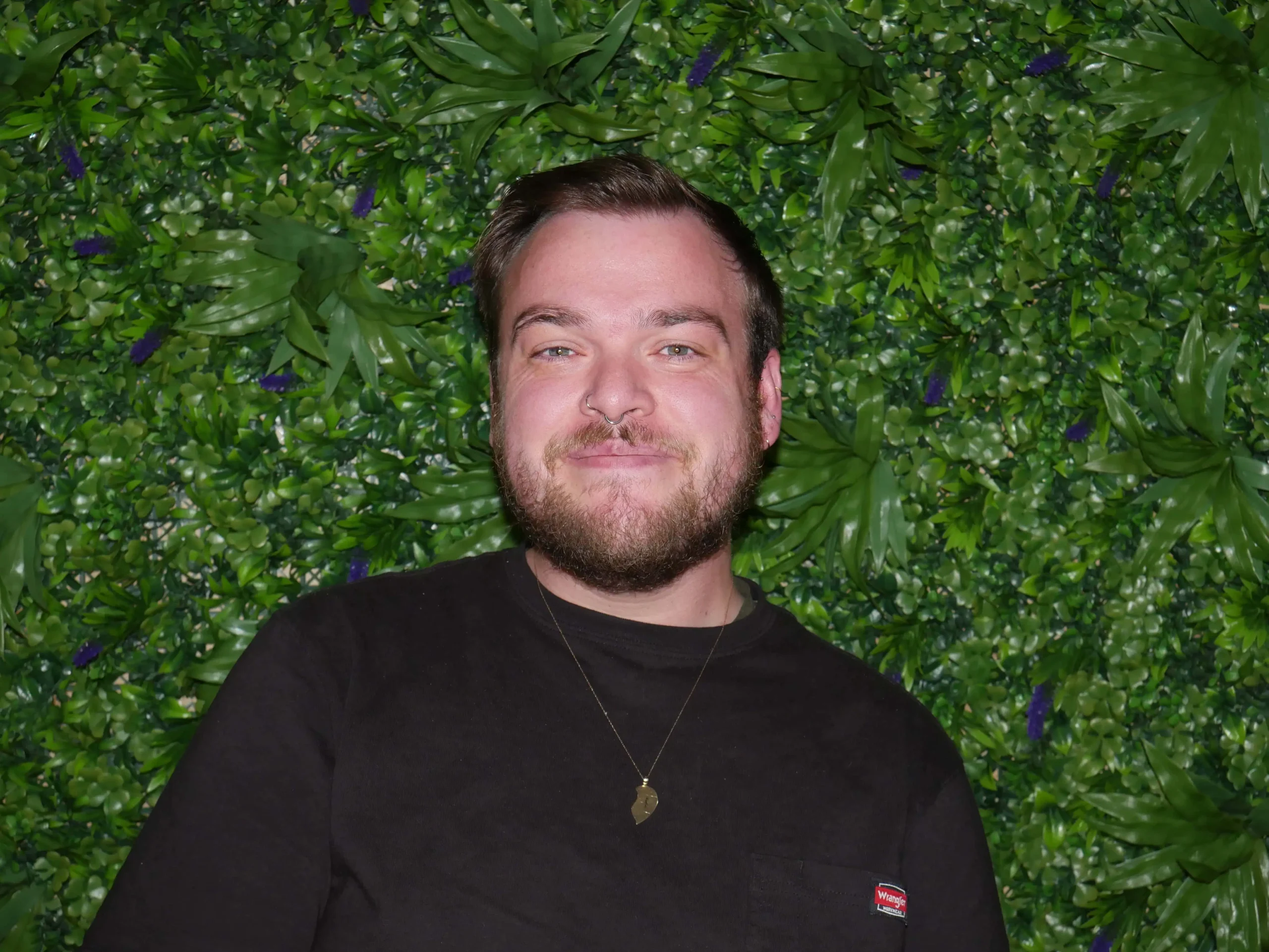 a man in front of a green wall